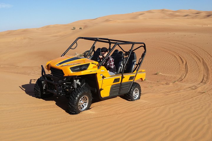 Experience the golden dunes of Arabia while driving a buggy through the stunning landscape perfect for adventure seekers looking to explore the desert's natural beauty.